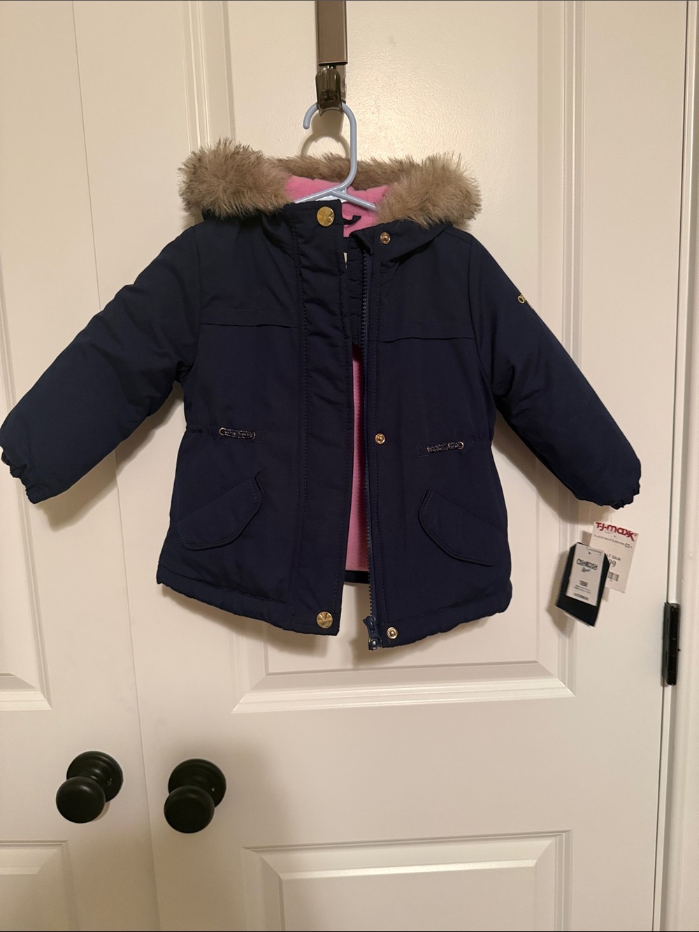 Girls winter coat with hood. Navy blue outside with pink fleece inside